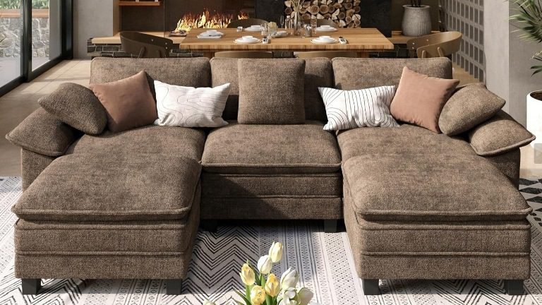 A 3-seater U-shaped sectional sofa with an ottoman is perfect for apartment living rooms because it offers enough seating for family or guests without occupying too much space. Many modern designs also feature soft chenille upholstery and deep-seat cushions, which provide a cozy, cloud-like seating experience.